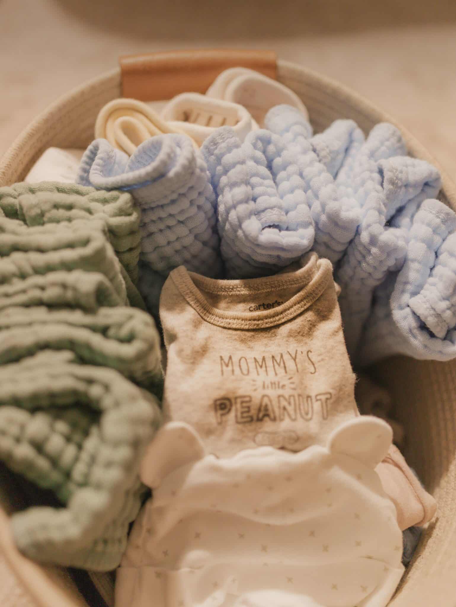 Basket of donated baby layettes, blankets, and onesies for the Christ Child Society of Milwaukee.