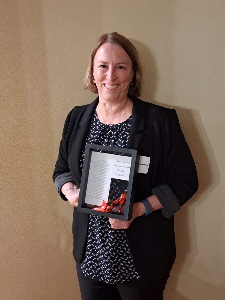 Ann Lamberg receiving the 2026 Red Shoe Award from the Christ Child Society of Milwaukee.